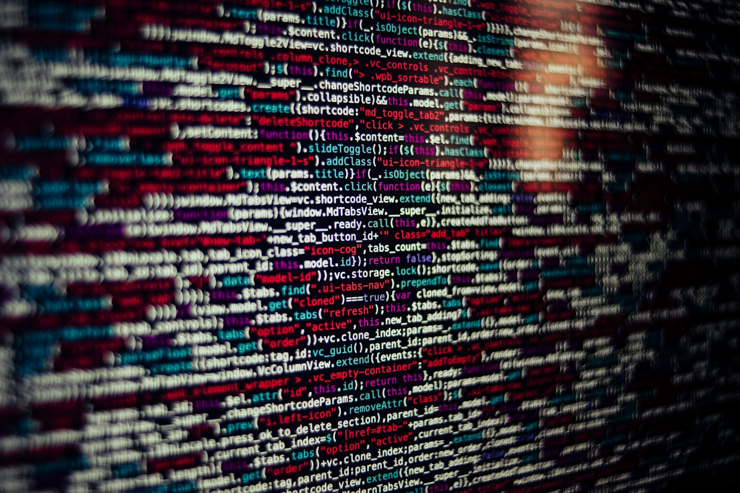 Lines of colorful computer code on a dark screen.